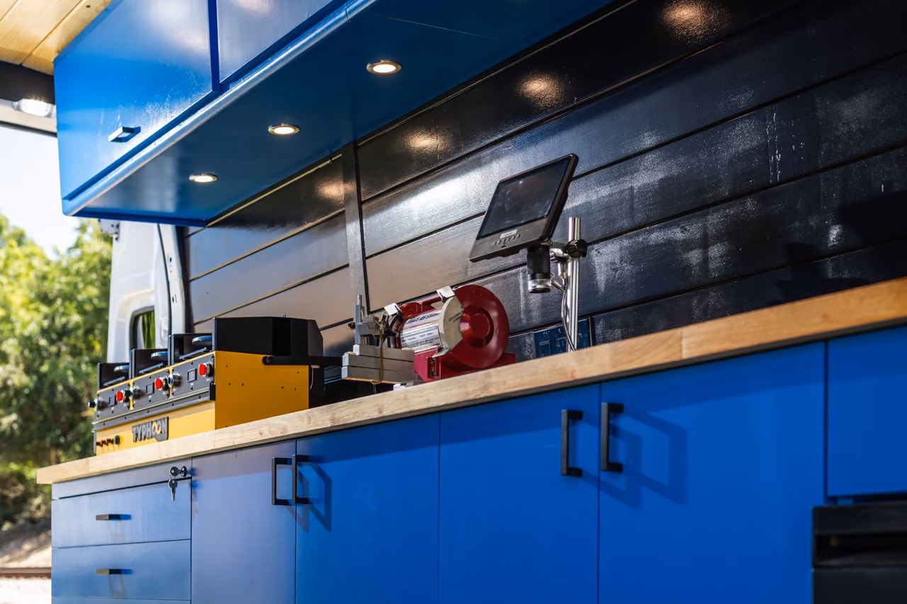 Blade-sharpening equipment on the workbench inside the Sheer Craftsmen custom mobile workshop van.